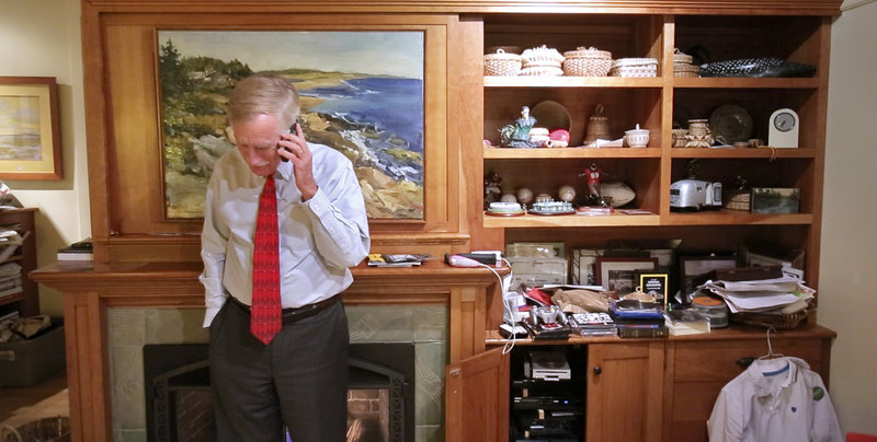 Angus King talks on the phone with his daughter, Molly, after returning home from campaigning last week. Molly, a freshman in college in New York, asked about what King thought of a candidate forum earlier that day and for pictures of the family pets.
