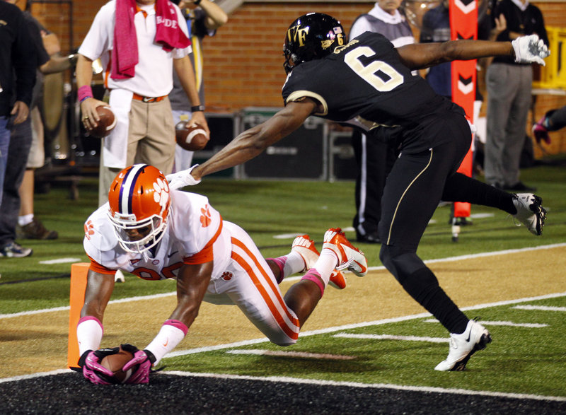 Clemson’s Brandon Ford dives into the end zone for a touchdown as Wake Forest’s Chibuikem Okoro defends during the first half at Winston-Salem, N.C. on Thursday night.