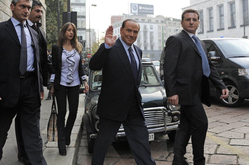 Italian Premier Silvio Berlusconi salutes as he arrives for a court hearing in Milan last week. On Friday, he was convicted of tax fraud but remains free while appeals are exhausted.