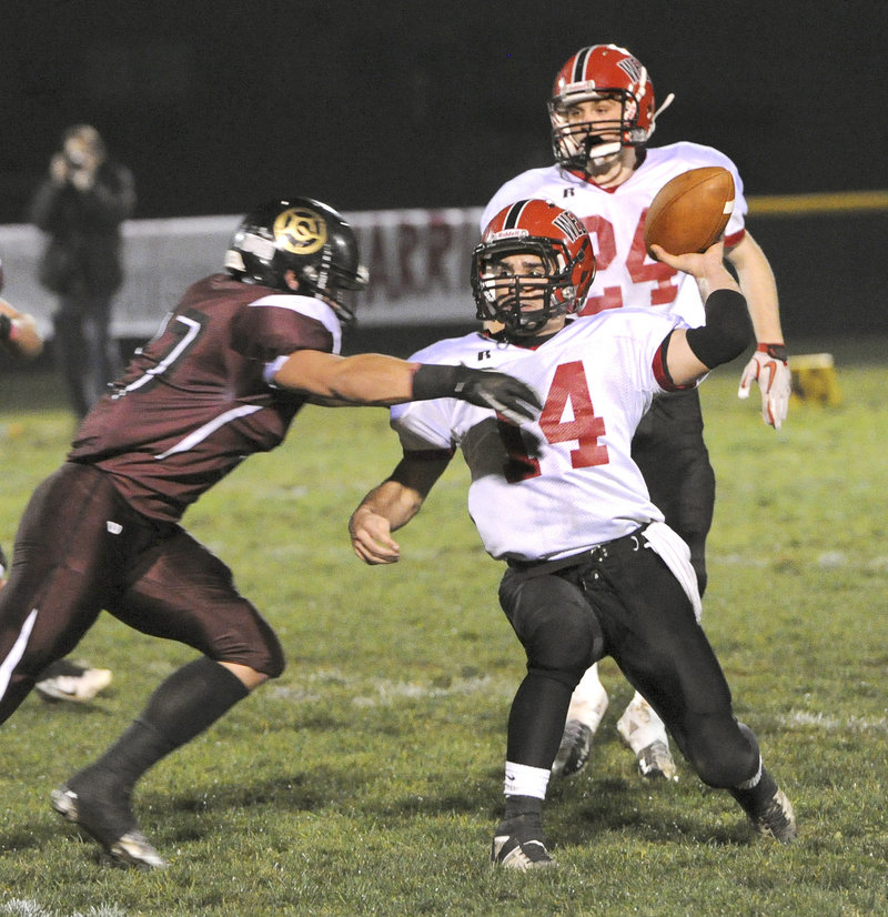 Wells quarterback Gavin Snapp attempts to get off a pass Friday night while pressured by Svenn Jacobson of Greely. Wells will take on top-ranked Marshwood in the semifinals.
