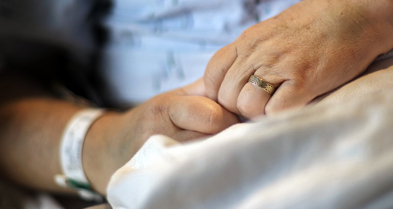 Joseph Stackpole wears his wedding band while in his hospital bed at Maine Medical Center on Friday.