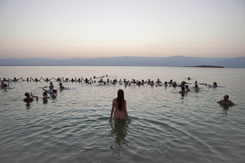 Environmental and social activists from Israel and around the world gather at the Dead Sea for a protest float led by photographer Spencer Tunick against the deterioration of the sea’s condition last month.