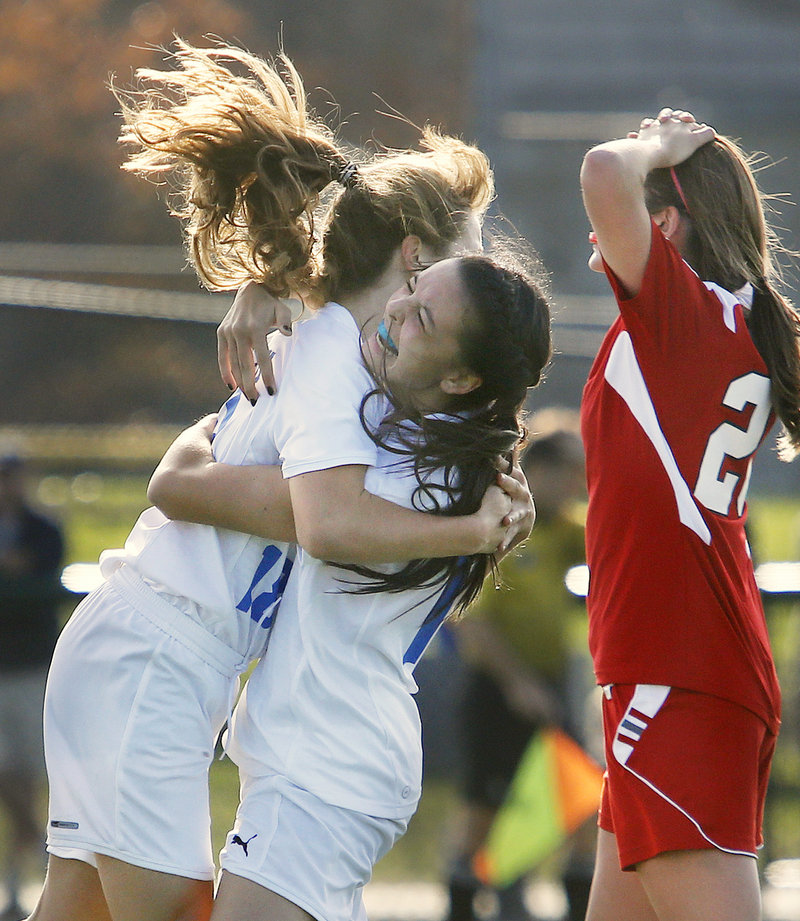 Cassie Darrow, left, gets a congratulatory hug from Falmouth teammate Megan Miller after scoring the second of her two goals in Saturday’s 2-1 Western Class B semifinal victory over Gray-New Gloucester.