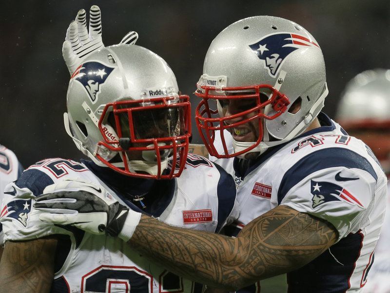 New England Patriots running back Stevan Ridley is congratulated by tight end Michael Hoomanawanui, after Ridley’s touchdown against the St. Louis Rams on Sunday at Wembley Stadium in London. The Patriots improved to 5-3 as they head into a bye week.