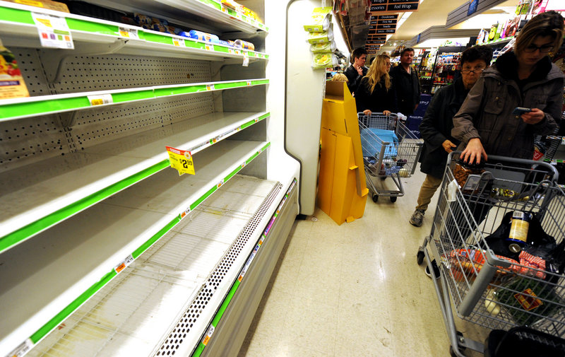 Customers shop for food in Manhattan on Sunday. Hundreds of thousands were ordered to evacuate coastal areas, including 375,000 in lower Manhattan and other parts of New York.