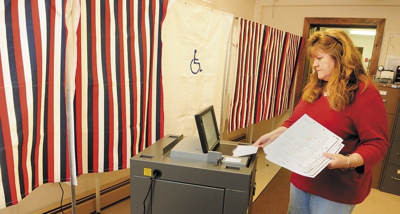 Chelsea Town Clerk Lisa Gilliam runs a test on the town’s new electronic vote-counting machine, one of 65 provided to smaller Maine municipalities as a result of the 2002 Help America Vote Act.