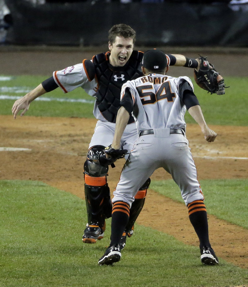 San Francisco reliever Sergio Romo, right, and catcher Buster Posey get ready to celebrate the Giants’ clinching 4-3 World Series win on Sunday at Detroit. Romo struck out the side in the 10th inning to seal the win.