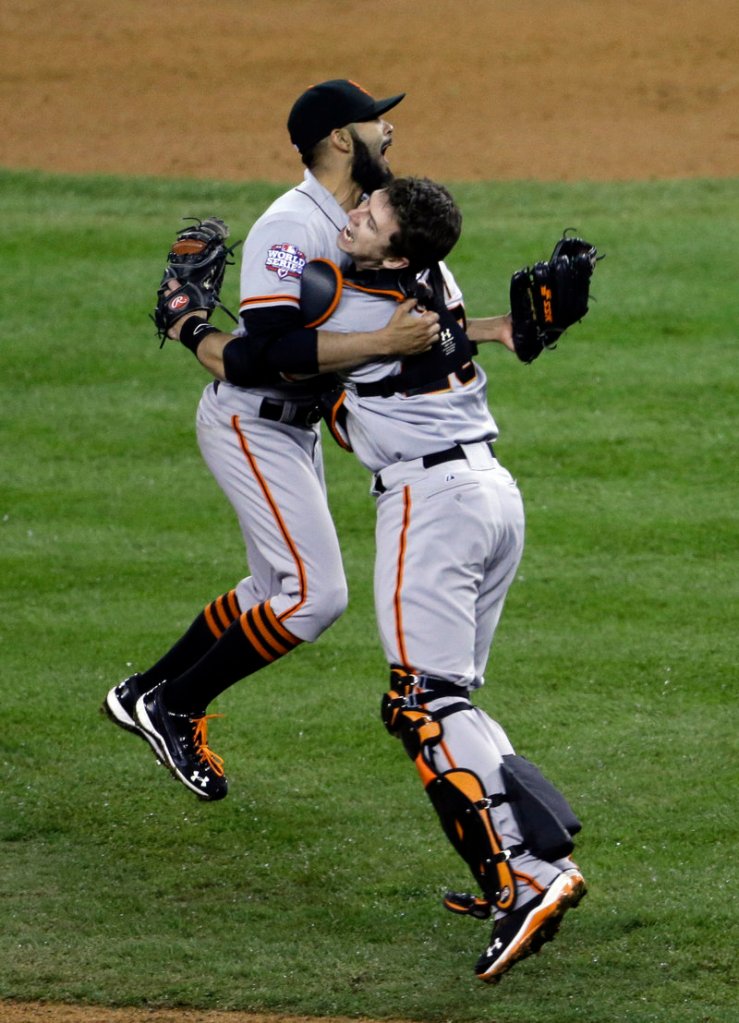 San Francisco Giant's catcher Buster Posey and pitcher Sergio Romo celebrate defeating the Detroit Tigers in Game 4.