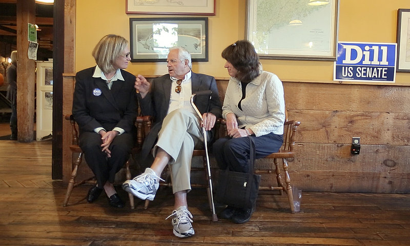 Cynthia Dill talks with Skip Clark, center, and Janet Saurman, right, at a campaign fundraiser at the Run of the Mill Public House in Saco last Friday. Dill has worked to dispel the idea that voting for her will help elect Republican Charlie Summers.