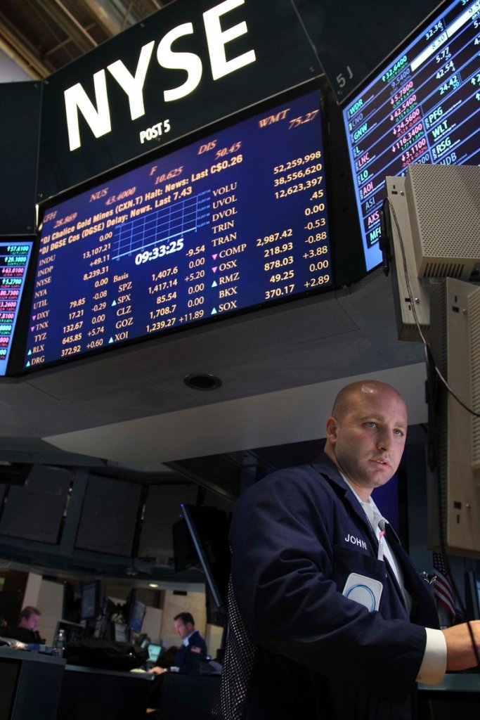 Traders resume working on the floor at the New York Stock Exchange Wednesday, although much of New York is still beset by snarled traffic, power outages and flooded streets and subways.