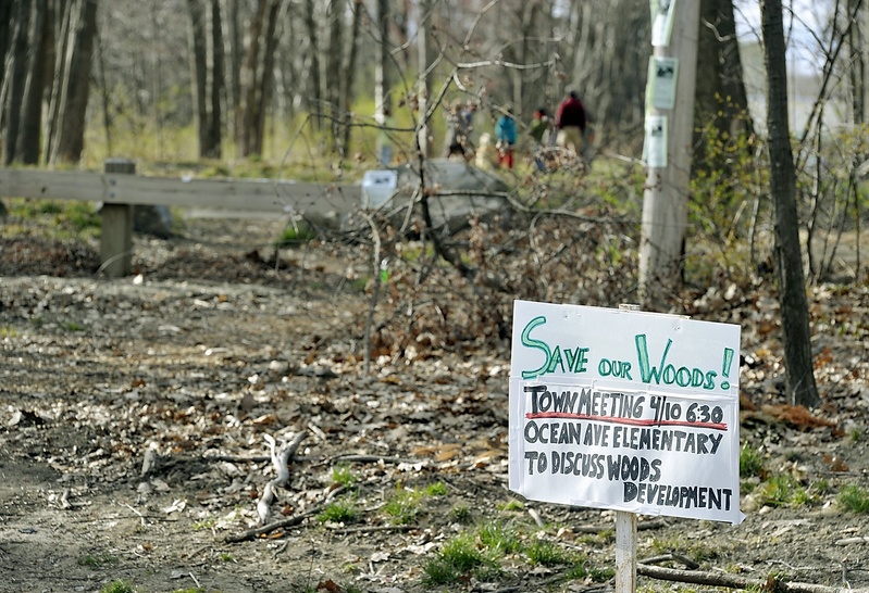 Neighbors of Canco Woods posted signs in April announcing a meeting to brainstorm ways to save their woods from industrial development. It has long been used as a park.