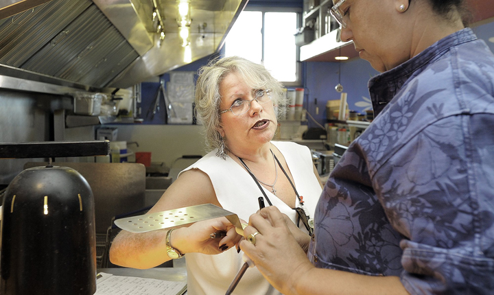 Portland health inspector Michele Sturgeon inspects the kitchen of a Portland restaurant in this Sept. 24, 2012, photo.