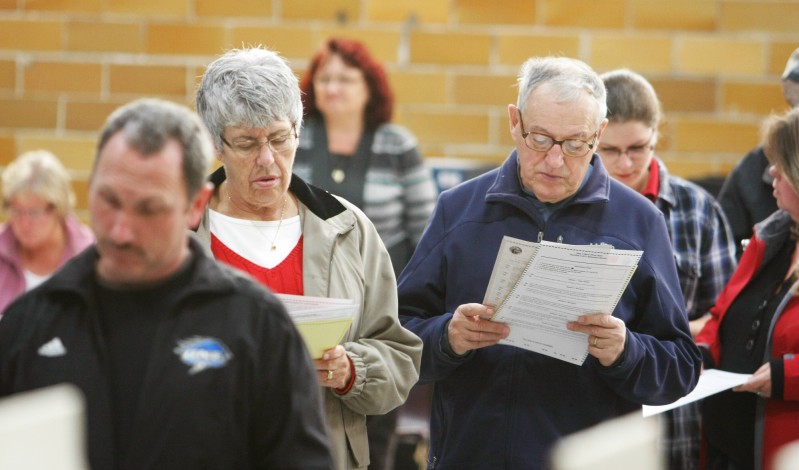 Doris and Julian Lambert look over their ballots while waiting in line to vote at the J. Richard Martin Community Center in Biddeford Tuesday, November 6, 2012. Jill Brady/Staff Photographer
