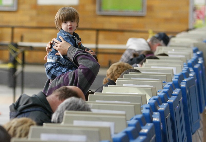 Lincoln Paquet, 2, sits atop the shoulders of Jim Giroux while voting at the J. Richard Martin Community Center in Biddeford Tuesday, November 6, 2012. Jill Brady/Staff Photographer