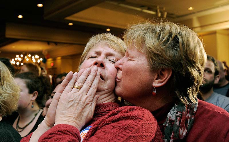 Ellie MacCallum, left, of Windham, receives a kiss from her partner, Judy Eycleshymer, right, after they learned same sex marriage had passed while at the Mainers United for Marriage party at the Holiday Inn by the Bay Tuesday, November 6, 2012.
