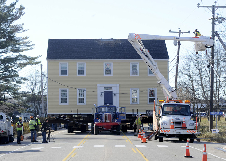 The historic Storer Garrison House is moved several hundred yards along Route 1 in Wells Friday to its new home at Mike's Clam Shack owned by Michael McDermott.