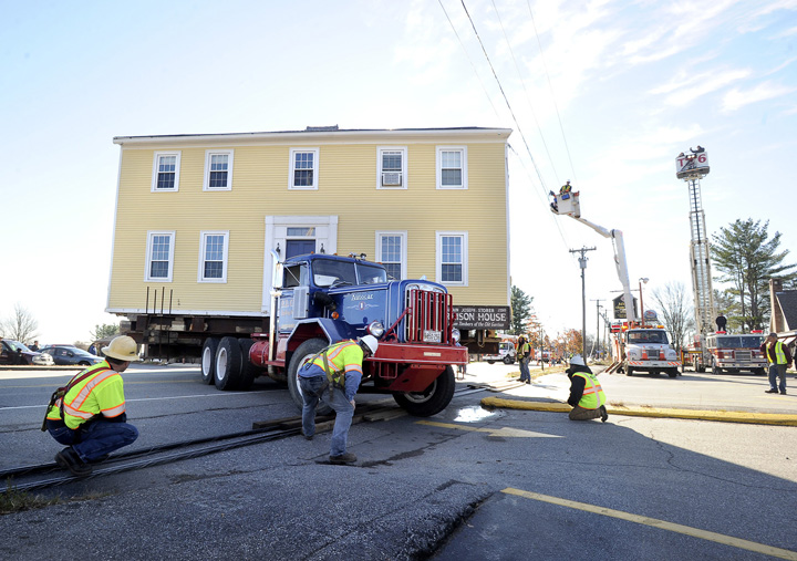 The historic Storer Garrison House is moves over utility lines that were lowered to allow its passage along Route 1 in Wells on Friday.