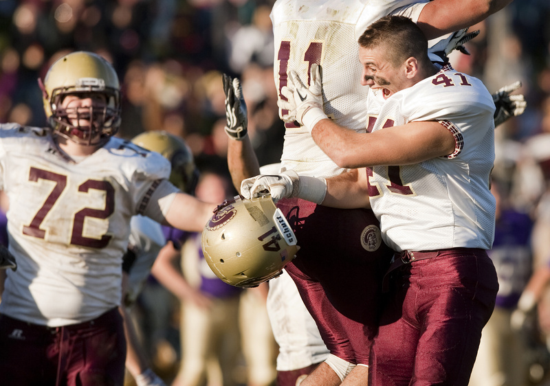 Thornton Academy players David LePauloue, left, and Josh Cyr celebrate after beating Cheverus in the Western Maine Class A football championship at Cheverus in Portland on Saturday.