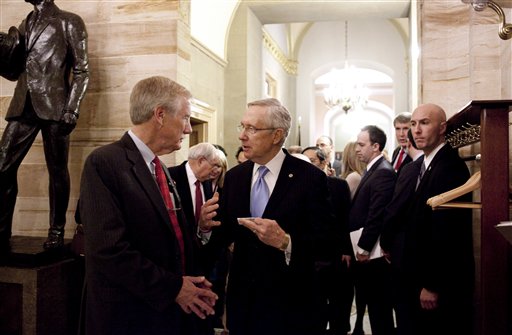 Sen.-elect Angus King, I-Maine, talks with Senate Majority Leader Harry Reid of Nev., on Capitol Hill in Washington, Wednesday, Nov. 14,2012, after King announced that he will caucus with the Democrats in the 113th Congress. (AP Photo/Harry Hamburg)