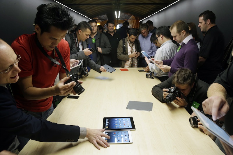 The iPad Mini is examined in San Jose, Calif., Tuesday, Oct. 23, 2012. Apple Inc. is refusing to compete on price with its rivals in the tablet market, it's pricing its new, smaller iPad well above the competition. On Tuesday, the company revealed the iPad Mini, with a screen that's about two-thirds the size of the full-size model, and said it will cost $329 and up. (AP Photo/Marcio Jose Sanchez)