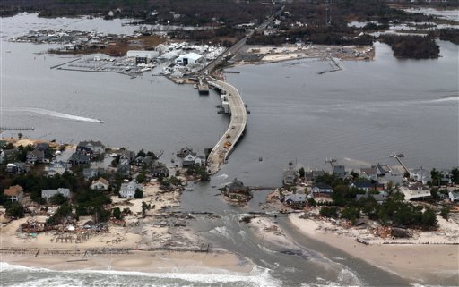 This aerial photo made from a helicopter shows storm damage from Sandy over the Atlantic Coast in Mantoloking, N.J., on Wednesday. The photo was made from a helicopter behind the helicopter carrying President Obama and New Jersey Gov. Chris Christie, as they viewed storm damage from superstorm Sandy.