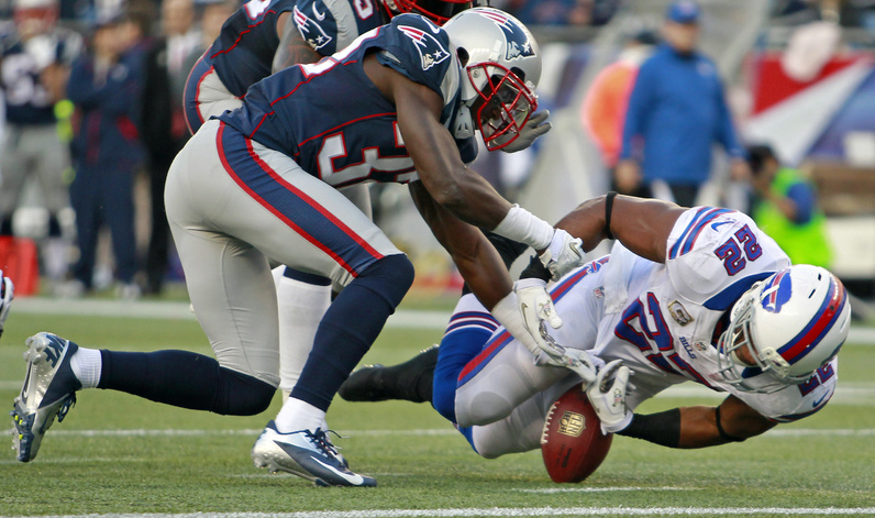 Buffalo Bills running back Fred Jackson fumbles the ball as New England Patriots cornerback Devin McCourty chases it during the fourth quarter of Sunday's game at Gillette Stadium in Foxborough, Mass. New England challenged the call on the play after it was initially ruled not to be a fumble that was recovered by the Patriots. Gillette Stadium,NFLACTION12
