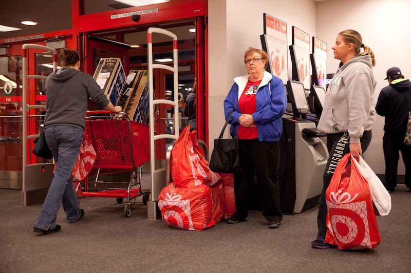 Shoppers make their way out of Target during their Black Friday sales event in Flint, Mich. on Thursday, Nov. 22, 2012. (AP Photo/Flint Journal, Griffin Moores)