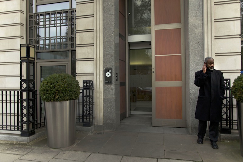 A security man stands guard outside the headquarters building of British oil company BP in London, Thursday, Nov. 15, 2012. BP said Thursday it is in advanced talks with U.S. agencies about settling criminal and other claims from the Gulf of Mexico well blowout two years ago. The explosion and fire aboard the Deepwater Horizon rig on April 20, 2010, killed 11 workers and set off a spill which continued for 87 days, fouling large areas of the southern coast of the United States. (AP Photo/Matt Dunham)