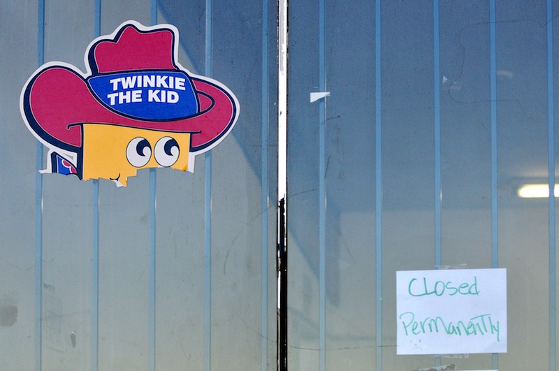 The head of Twinkie The Kid poster remains on the Wonder Hostess Bakery Outlet store in Victorville, Calif, where a posted sign displays "closed permanently," at the empty commercial property on Tuesday, Nov. 20, 2012. The store's last day open to the public was on Saturday, Nov. 17, 2012. (AP Photo/The Victor Valley Daily Press, David Pardo) HOSTESS