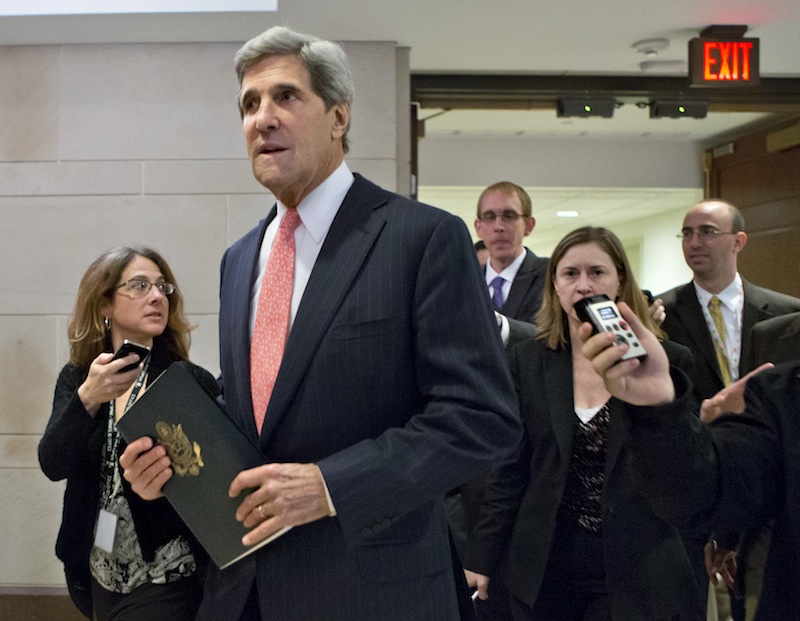 This Nov. 13, 2012 file photo shows Senate Foreign Relations Committee Chairman, Sen. John Kerry, D-Mass. pursued by reporters as he arrives for a closed-door meetin on Capitol Hill in Washington. Kerry is angling for the nation’s top diplomatic job by being diplomatic. He's asking supporters not to overtly lobby on his behalf, a strategy reflecting both his disdain for Washington’s personnel politics and a recognition that if Obama taps Rice instead, Kerry will have to shepherd her difficult nomination through the Senate committee he runs. (AP Photo/J. Scott Applewhite, File)