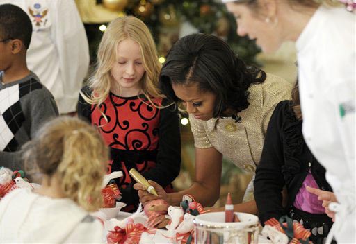 First lady Michelle Obama decorates a lollipop during a holiday decoration preview at the White House on Wednesday.