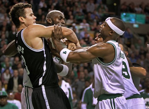 Boston Celtics Kevin Garnett, rear center, Rajon Rondo, rear right, and Jason Terry clash with Brooklyn Nets Kris Humphries, left, during Wednesday's game in Boston. The Nets won 95-83.