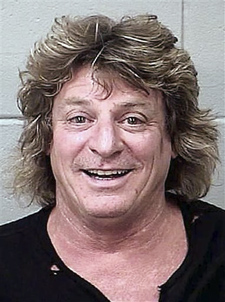This July 9, 2012 booking photo provided by the Bangor, Maine, Police Department shows Mick Brown, drummer for classic rocker Ted Nugent, arrested in Bangor Sunday night, July 8, 2012, in Bangor. Brown, of Cave Creek, Ariz., was charged with driving drunk in a golf cart stolen from a concert venue. (AP Photo/Bangor Police Department)