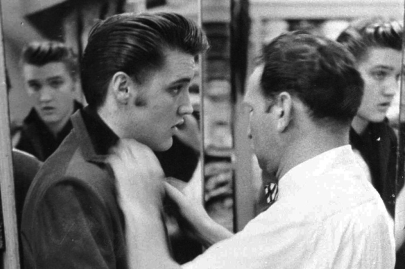 This 1956 photo originally released courtesy of clothier Bernard Lansky shows singer Elvis Presley being outfitted by Lansky at Lansky’s Men’s Store in Memphis, Tenn.