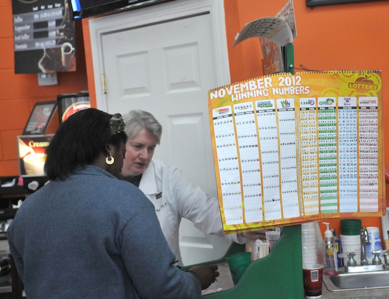 Shoppers fill out forms to purchase lottery tickets Tuesday afternoon at the Shell Station on Chatham Parkway in Savannah, Ga. Powerball ticket slaes have been brisk and the jackpot has risen to $500 Million.