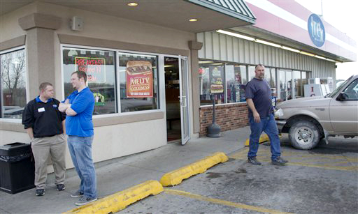 An unidentified customer walks out of the Trex Mart convenience store in Dearborn, Mo., where Mark and Cindy Hill purchased one of the two winning Powerball tickets.