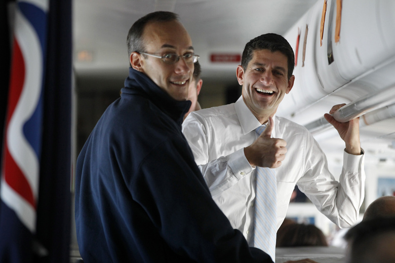 Rep. Paul Ryan, R-Wis., the Republican vice presidential candidate, gives the press a thumbs-up while speaking to senior adviser Dan Senor on board the campaign charter airplane en route to Cleveland Tuesday.