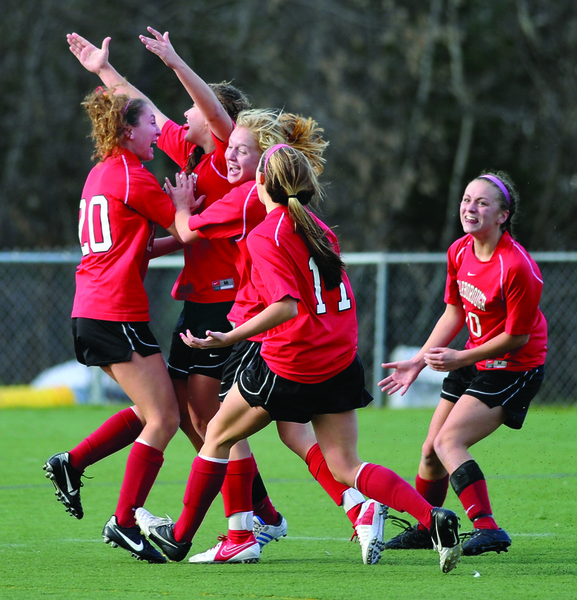 Sarah Martens raises her hands in the air and is swarmed by Scarborough teammates after scoring the winning goal in the second overtime in Saturday’s Class A state championship game at Hampden. The Red Storm beat Bangor, 2-1.