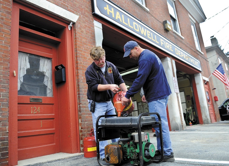 Hallowell firefighters Rick Seymour, left, and Roy Girard fuel up a generator at the city's station in preparation for the arrival of Hurricane Sandy.