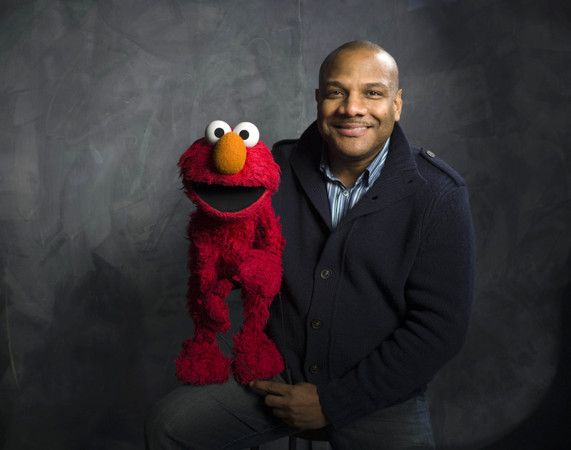 Kevin Clash poses for a portrait with "Sesame Street" muppet Elmo in 2011.