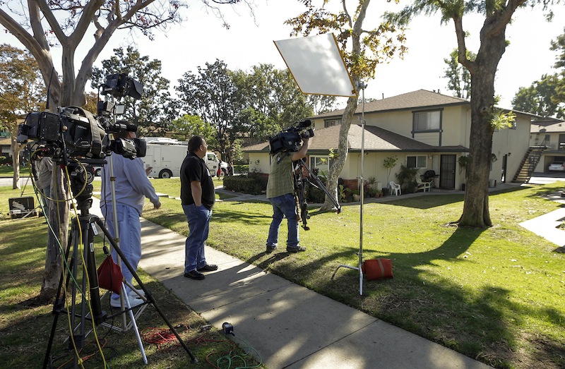 Members of the media gather outside the home of 21-year-old Miguel Alejandro Santana Vidriales of Upland, Calif. Tuesday, Nov. 20, 2012. Vidriales is one of four Southern California men charged with plotting to kill Americans and destroy U.S. targets overseas by joining al-Qaida and the Taliban in Afghanistan, federal officials said. In one online conversation, Santana told an FBI undercover agent that he wanted to commit jihad and expressed interest in a jihadist training camp in Jalalabad, Afghanistan. (AP Photo/Damian Dovarganes)