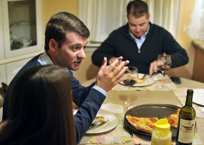 In this photo taken Friday, Nov. 16, 2012, Brian Malone, of Duxbury Mass., speaks about the recent presidential election, while gathered with his extended family including his wife Rebecca Malone, left, and brother-in-law Andrew Marshall, right, of Quincy Mass., during dinner at his in-law's house in Hingham, Mass., where politics is a frequent, and divisive topic of conversation. (AP Photo/Josh Reynolds)