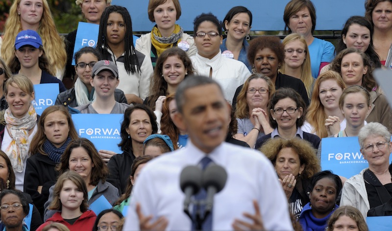 This Oct. 19, 2012 file photo shows thee audience, who were mostly women, listen behind President Barack Obama as he speaks about the choice facing women in the election during a campaign event at George Mason University in Fairfax, Va. Sorry, fellas, but President Barack Obama’s re-election makes it official: Women can overrule men at the ballot box. For the first time in research dating to 1952, the candidate whom the most men chose – Mitt Romney – lost. More women voted for the other guy. It’s surprising it didn’t happen sooner, since women have been voting in larger numbers than men for almost three decades, exit polls show. (AP Photo/Susan Walsh, File)
