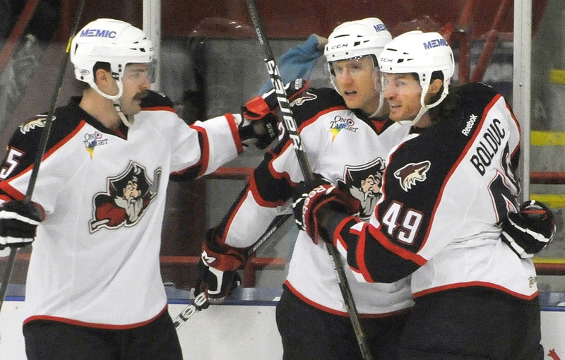 Chris Summers, left, and Alexandre Bolduc congratulate Rob Klinkhammer, center, on a goal in a Pirates game. They may soon be congratulating each other on food they’ve cooked.
