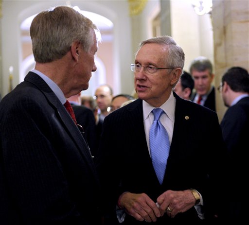 Senate Majority Leader Harry Reid of Nev., left, talks with Sen.-elect Angus King, I-Maine on Capitol Hill in Washington, Wednesday, Nov. 14, 2012. King said Wednesday he has decided to caucus with Democrats, which will add to the party's voting edge. (AP Photo/Susan Walsh)