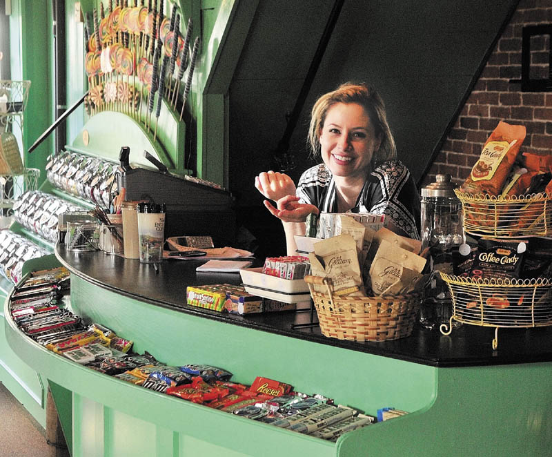 Hilary Davis behind the counter in the Scrummy Afters Novelty Candy Shoppe on Water Street in Hallowell.
