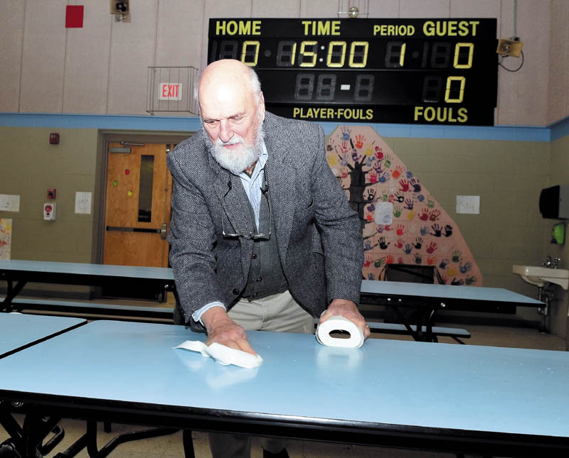 Cornville Regional Charter School Principal Bill Crumley pitched in and helped clean cafeteria tables recently.