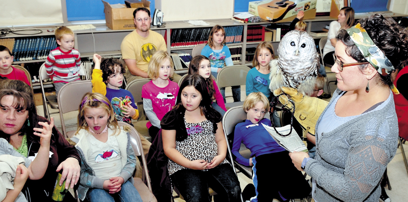 Kids at the Cornville Regional Charter School got to see live owls and bats during a Chewonki Foundation Traveling Natural History program on Thursday. Instructor Sarah Mortati shows and answers questions about the barred owl she held.