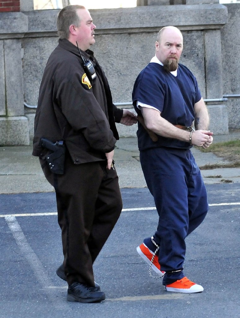 Robert Nelson is led into Somerset Superior Court in Skowhegan on Monday for the first day of his trial in the shooting death of Everett L. Cameron.