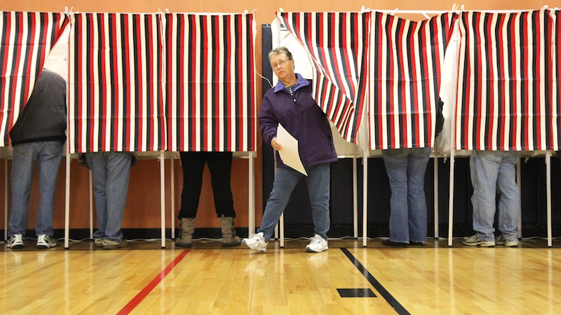 Jeannette Garland leaves a voting booth before casting her ballot at Mill Stream Elementary School in Norridgewock on Tuesday.